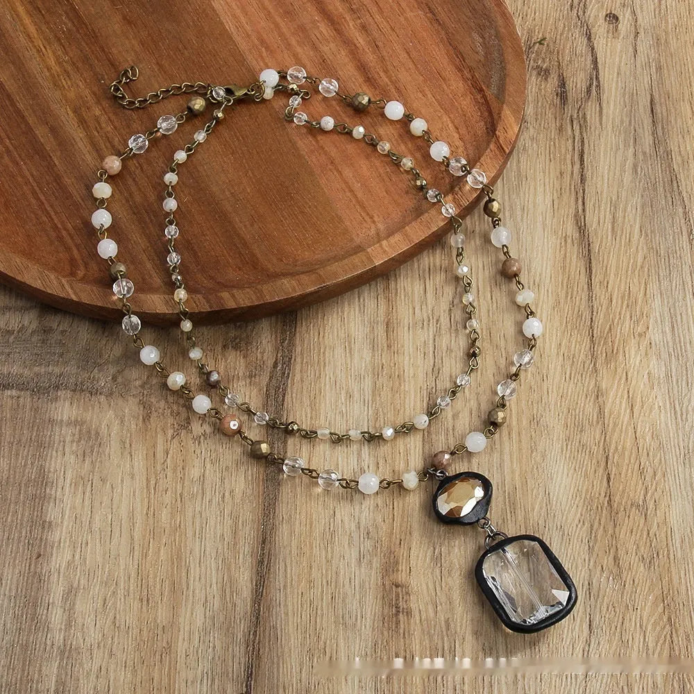 Tribal style two-layer chain necklace with stone and glass pendants in beige or blue colours