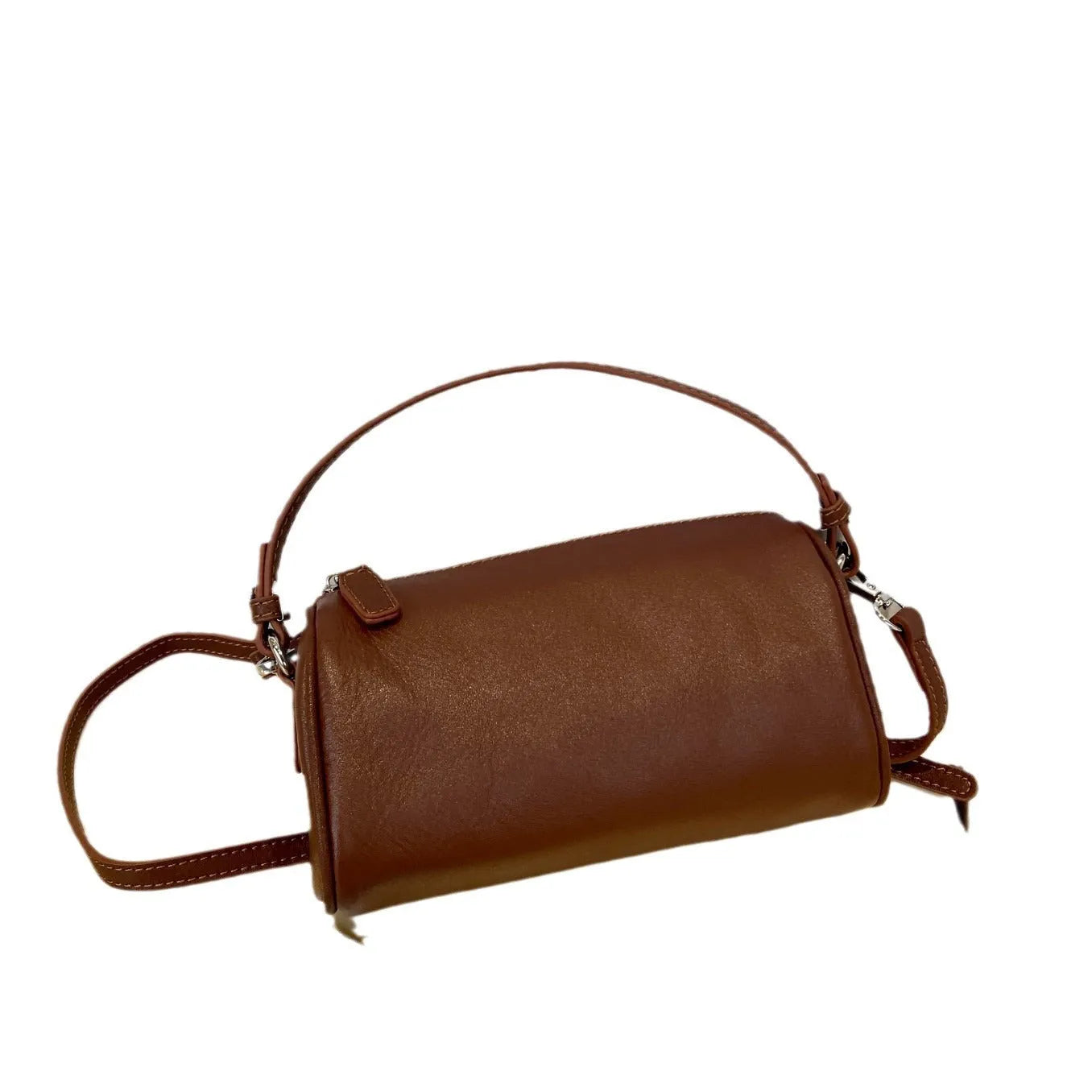 Brown cylindrical leather crossbody phone bag with visible stitching on a flat surface.