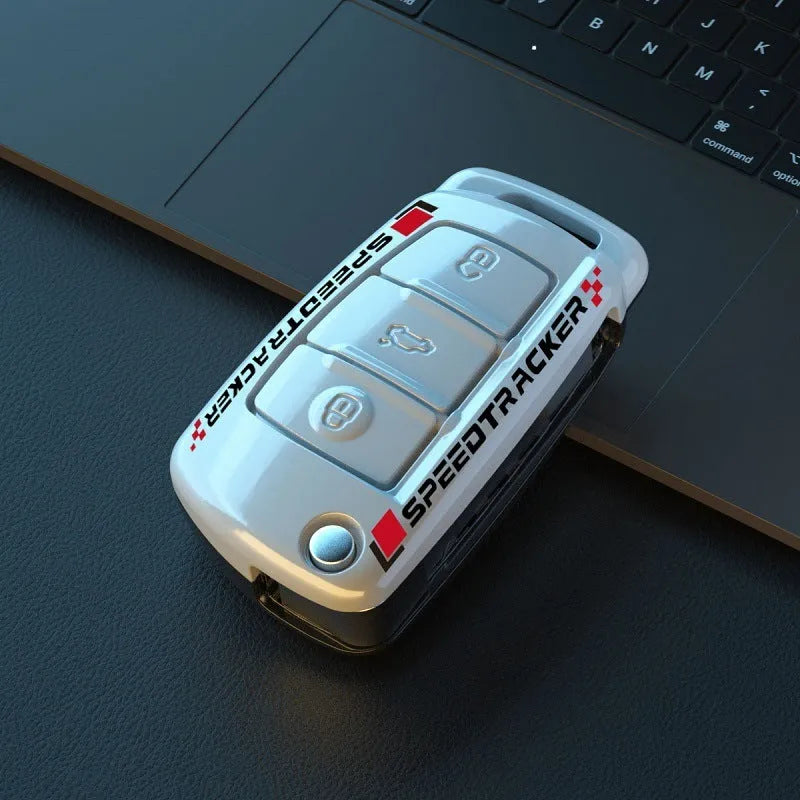 Carbon fibre style car key cover with a small mirror, shown in black and white colour options.