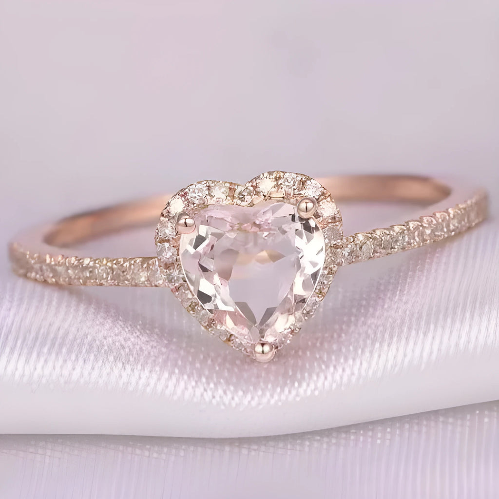 Women's fashion crystal heart-shaped ring in rose gold or silvery on a white background.