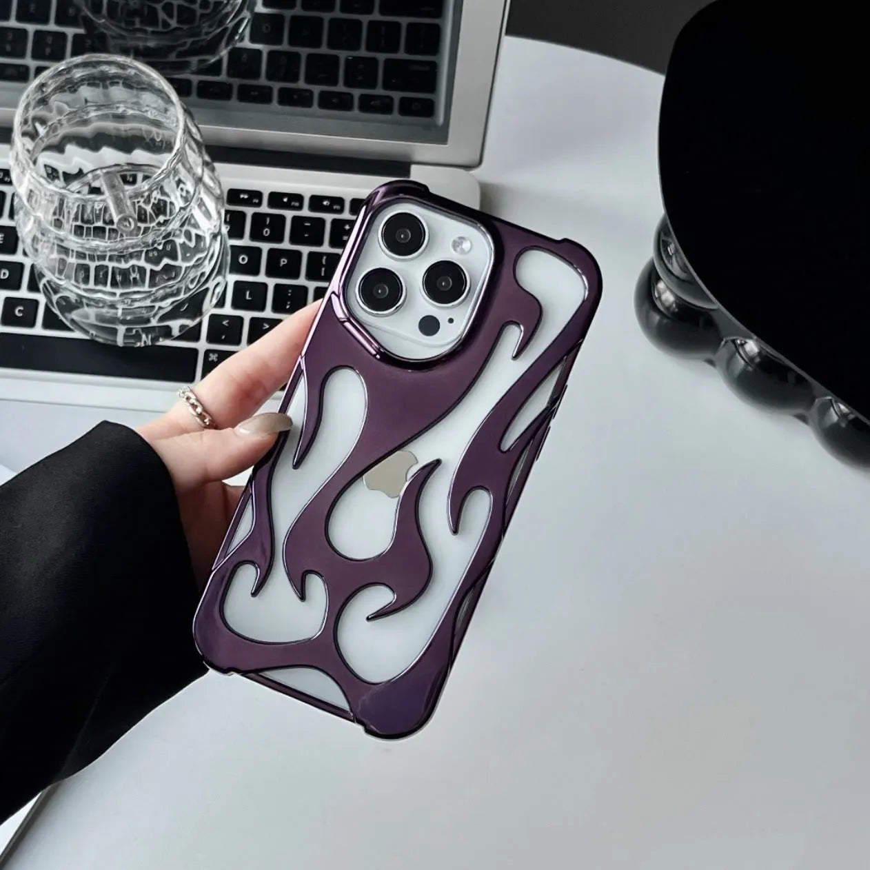 Electroplated hollow flame pattern design on a soft TPU iPhone case, shown in a silver finish.