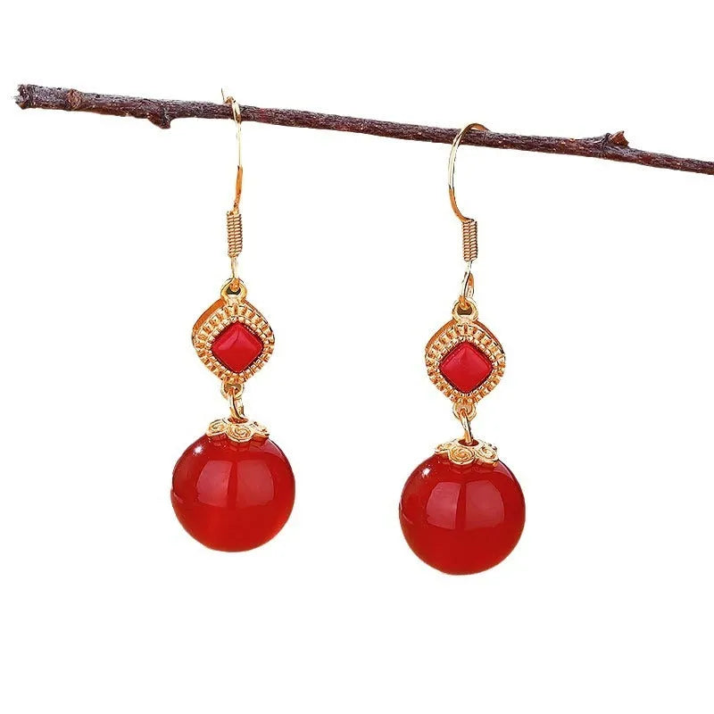 Geometric southern red agate and silver-inlaid jasper earrings with copper alloy posts.