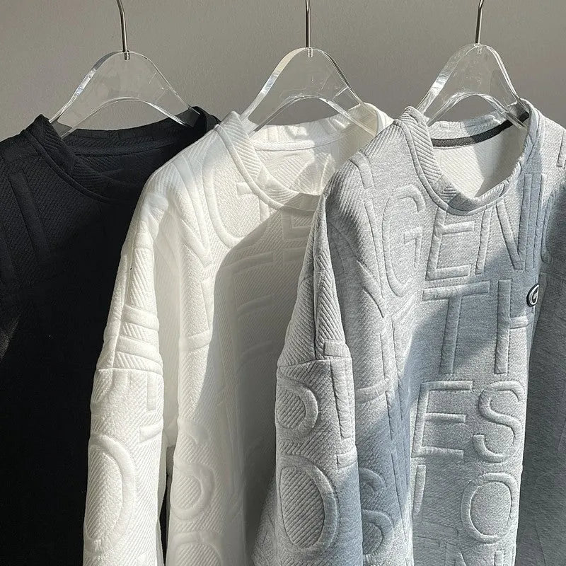 Men's grey loose-fit t-shirt with a raised black three-dimensional letter print on the front.