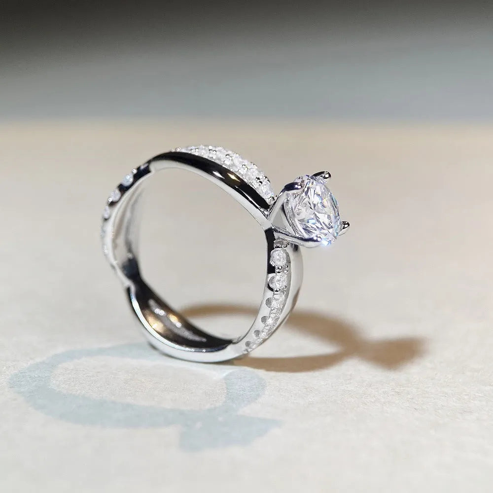 Geometric silver moissanite ring with twisted band and 1 karat centre stone in four-claw setting