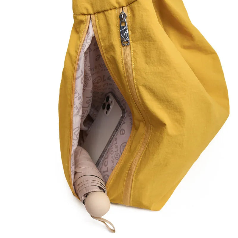 Nylon underarm bag in heart shape design showing large capacity, available in black, blue, khaki, and yellow colours
