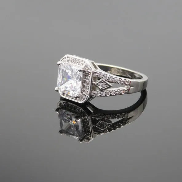 Geometric hollow design zircon ring in platinum-colour finish on copper, showing quadrilateral stone faceting