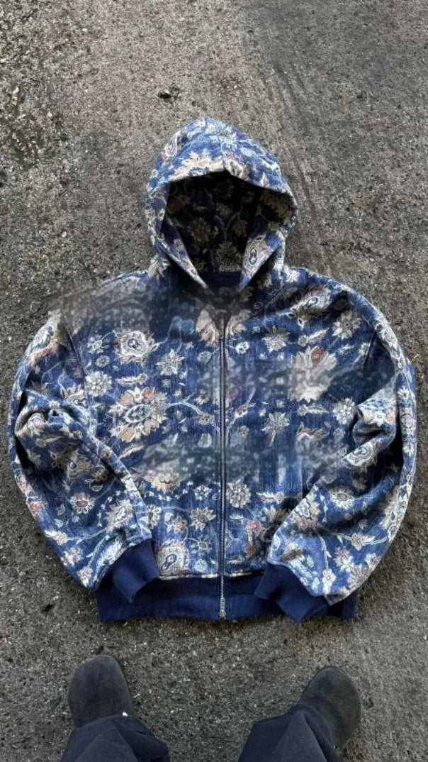 Blue loose fit men's hooded zip coat with front zip and long sleeves on a hanger.
