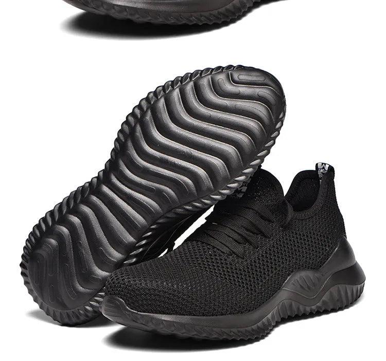Black low-cut steel toe safety shoes with anti-static EVA sole on a work surface