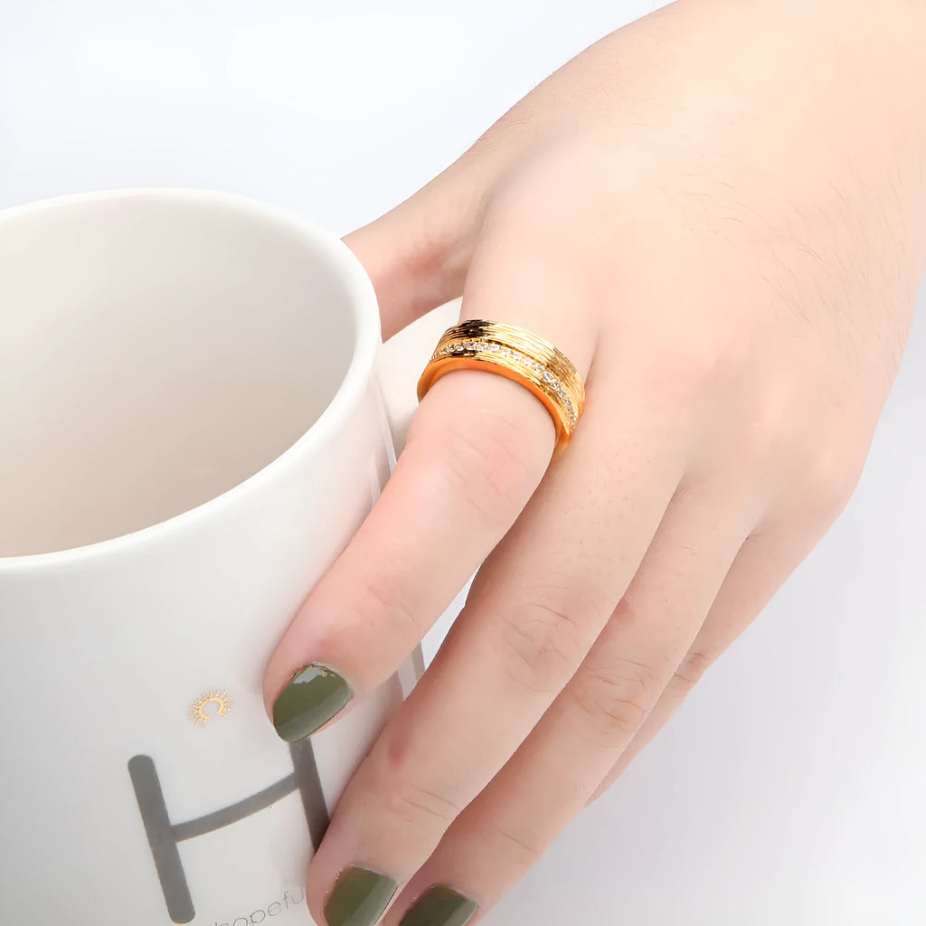 Gold geometric women's ring with zircon accents on a copper base, shown in UK sizes 6, 7, and 8.