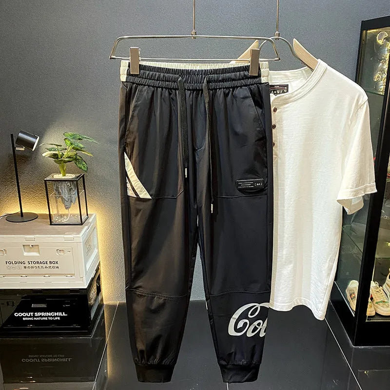 Men's black cropped ankle band trousers in ultra-thin ice silk cotton material showing casual styling