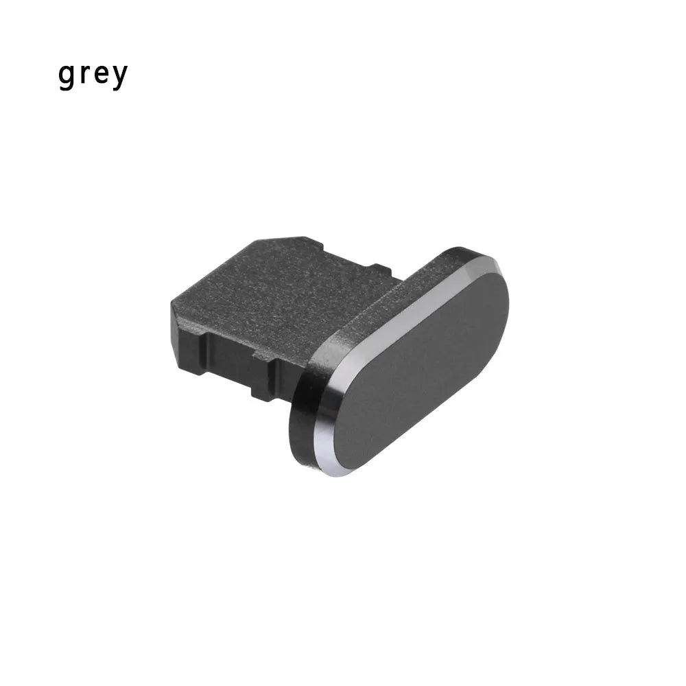 Aluminium alloy iPhone charging port dust plug in metallic colours on a dark background.