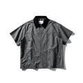 Washed khaki cotton overalls shirt with short sleeves and loose cardigan style on a hanger
