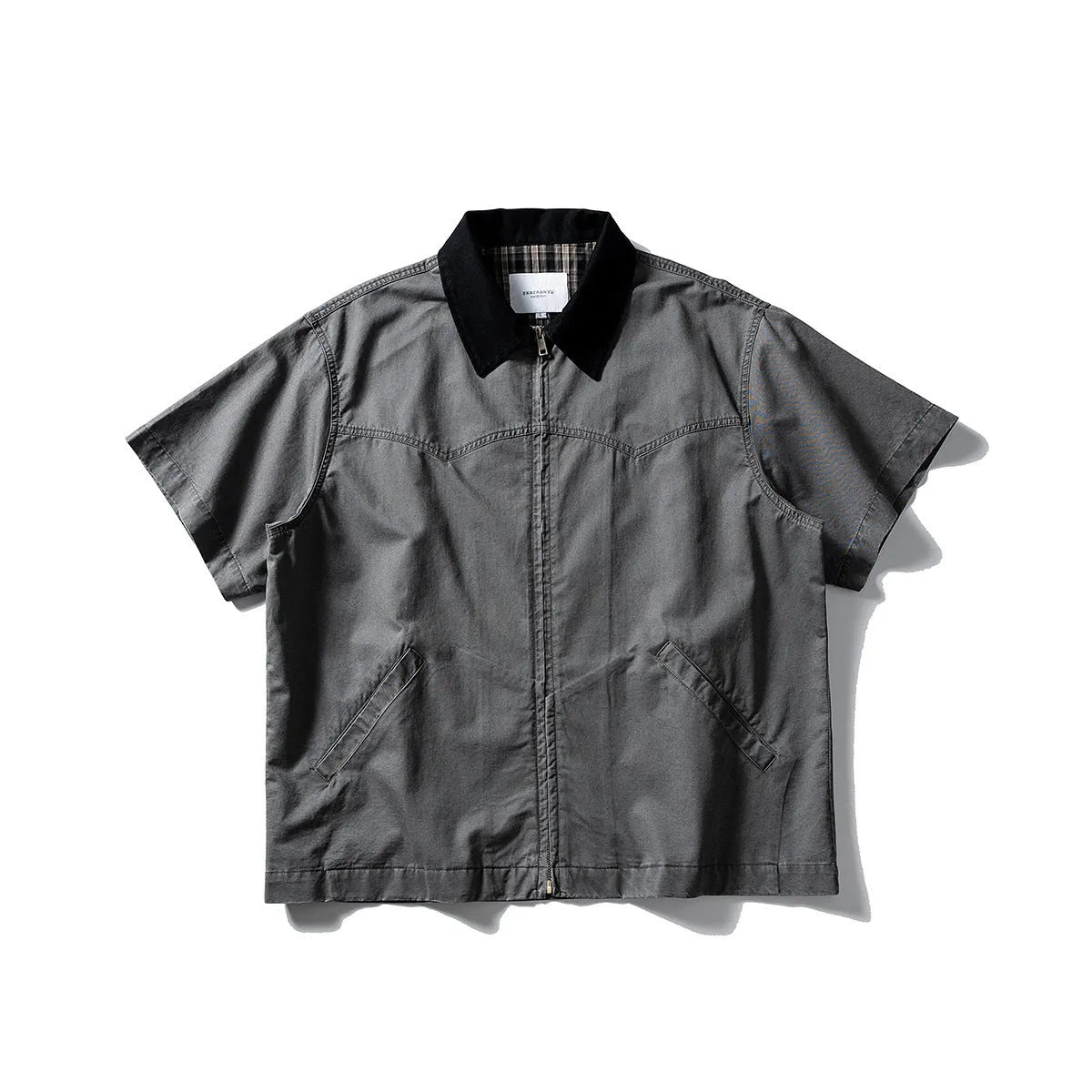 Washed khaki cotton overalls shirt with short sleeves and loose cardigan style on a hanger