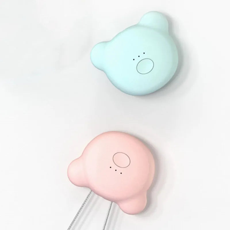 Mini USB portable air purifier necklace in pink, showing compact design with single button.