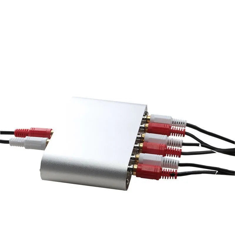 Silver aluminium audio source selector switch unit with front-panel buttons and infrared remote control.