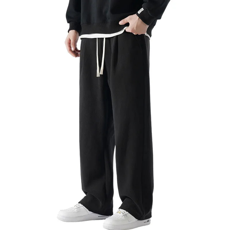 Men's apricot double-sided polar fleece-lined loose fit winter sports trousers on a hanger