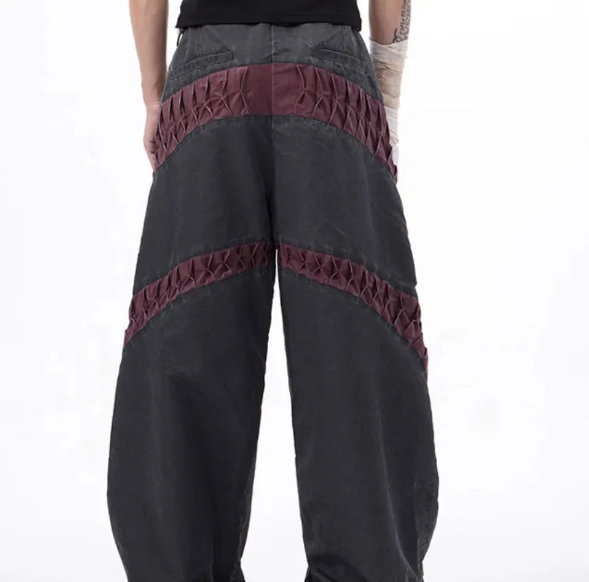 Men's slim-fit grey trousers with textured keel detailing on the legs.
