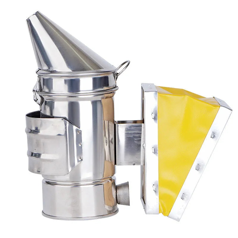 Portable stainless steel beekeeping smoker with leather bellows on a wooden surface