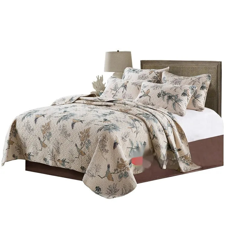 Quilted pure cotton bed cover set with printed pattern on a bed