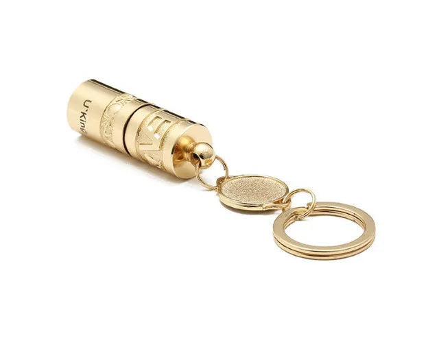 Gold zinc alloy waterproof LED keychain flashlight on a keyring.