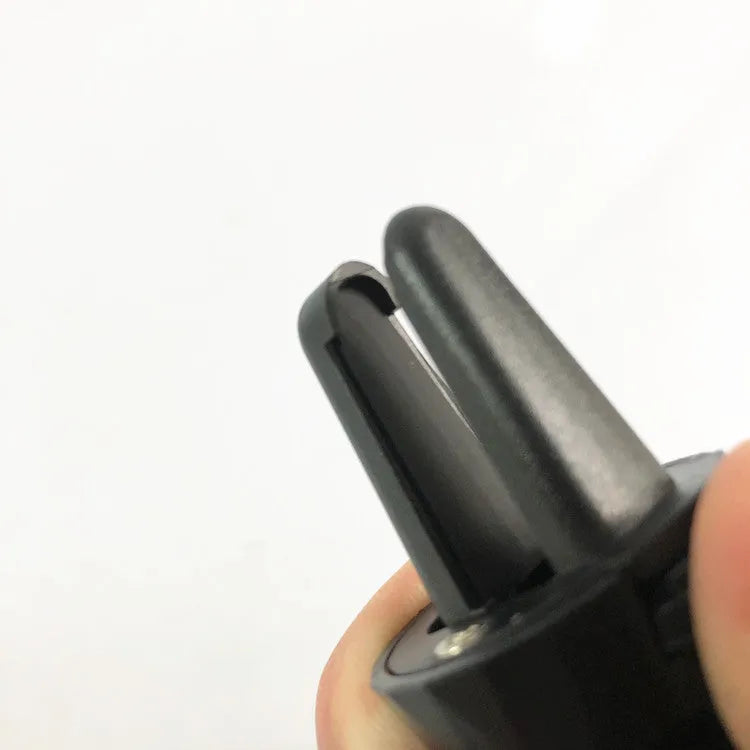 Black car phone holder mounted on car air vent with adjustable clamp and flexible positioning arm