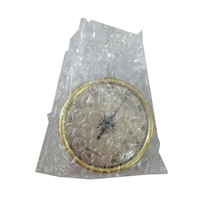 Analogue thermometer and hygrometer with silver aluminium outer ring and dial showing temperature and humidity scales.