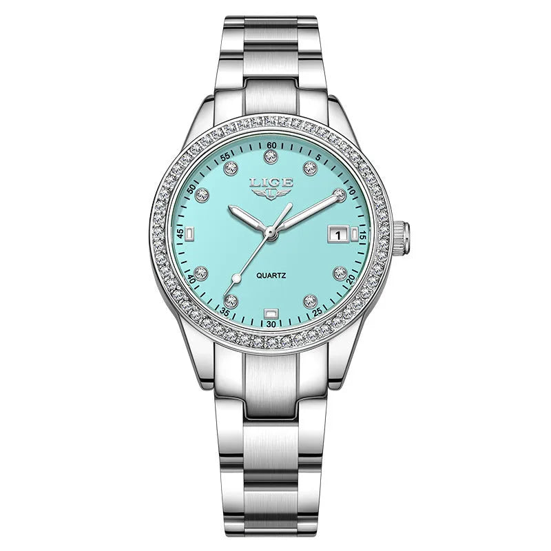 Silver-tone women's fashion watch with round dial, diamond bezel, and luminous hands on a wrist.