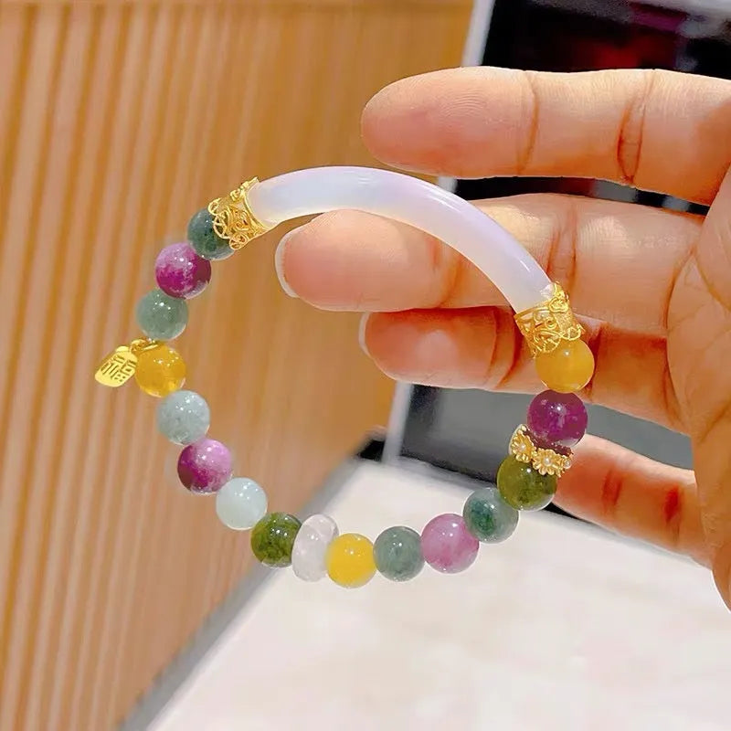 Natural rainbow coloured tourmaline gemstones on a women's jade pith half bracelet with electroplated finish.
