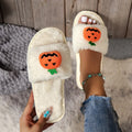 Halloween pumpkin plush slippers in white and yellow with synthetic fur and open toe design