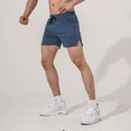 Man wearing straight-cut black polyester sports shorts for fitness or casual use.