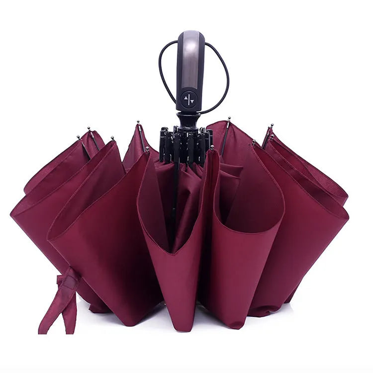Triple folding automatic black business umbrella with steel ribs and a rubber handle, shown in the open position.