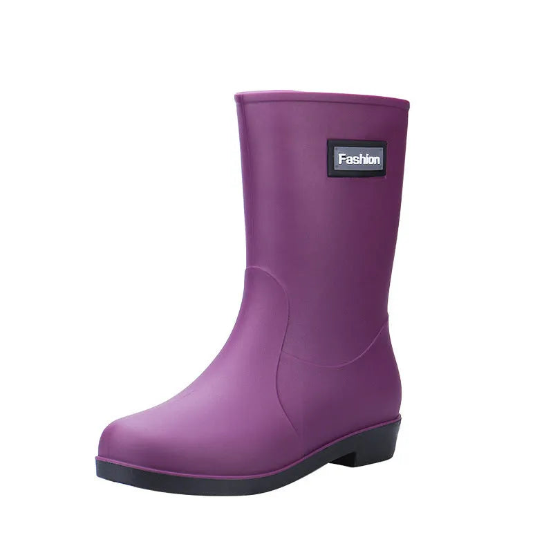 Women's mid-calf PVC rain boots in black with low heel, shown in short tube design