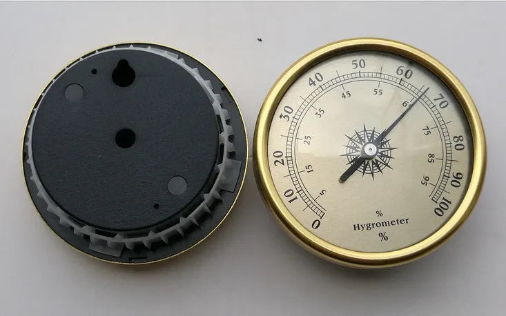 Analogue thermometer and hygrometer with silver aluminium outer ring and dial showing temperature and humidity scales.