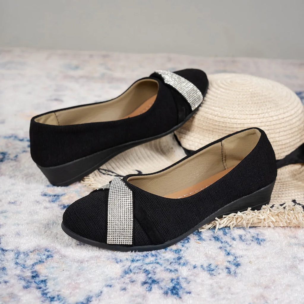 Women's black casual slip-on shoes with rhinestone detail, round toe, and a chunky heel.