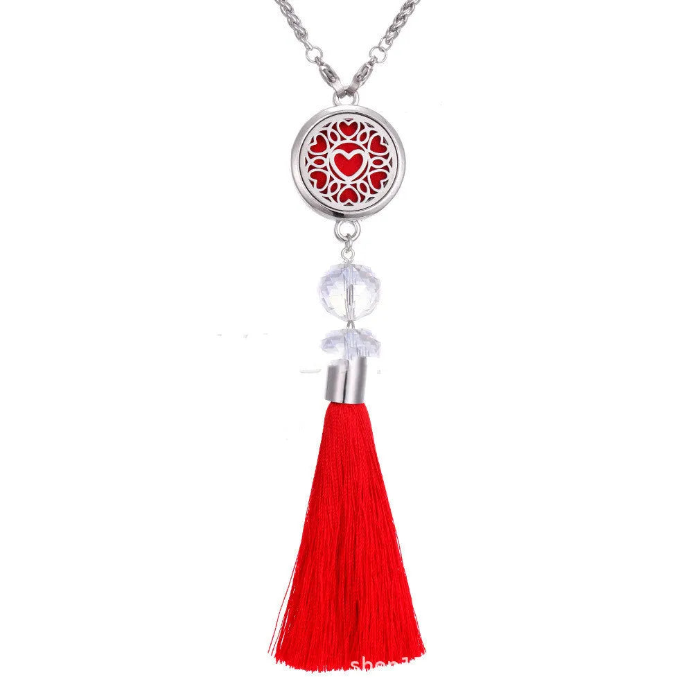 Alloy tassel-style car fragrance pendant with cotton pads hanging from rear-view mirror