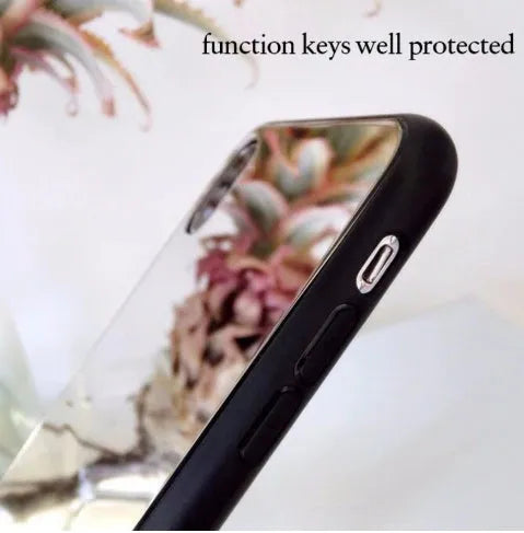 Black iPhone case with a mirrored back panel, shown next to an iPhone.