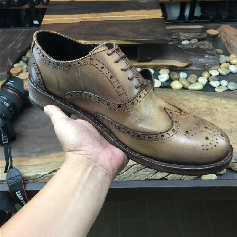 Men's light brown distressed leather shoes with vintage engraved detailing and round toe