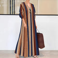 Camel coloured striped V-neck long sleeve knit dress with an A-line skirt on a hanger.