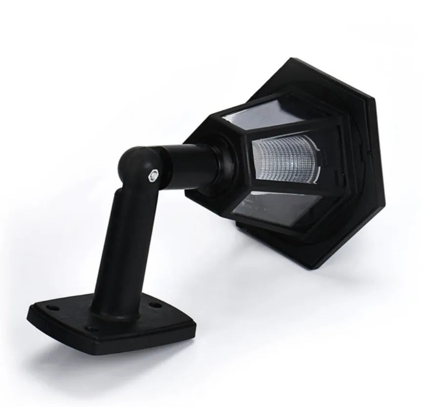 Black hexagonal solar wall light for outdoor mounting with automatic light sensor