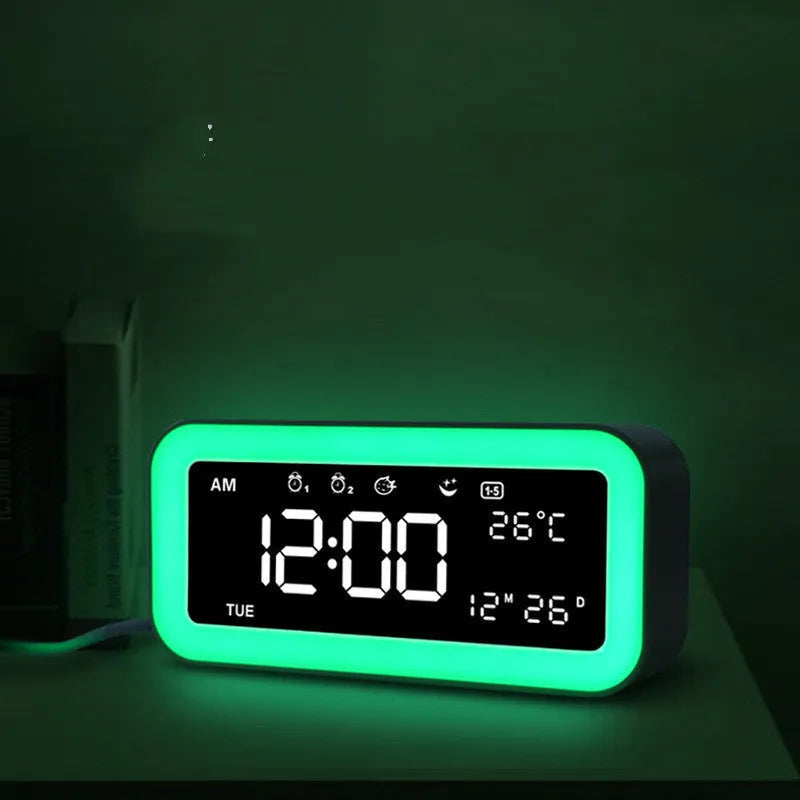 Rectangular blue LED alarm clock with digital display and multicoloured atmospheric lighting on bedside table