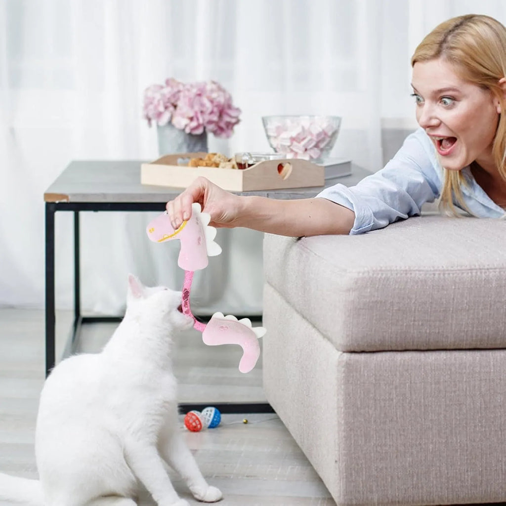 Set of four cat toys including plush chew toys, catnip rope, springs, and kicker toy on floor