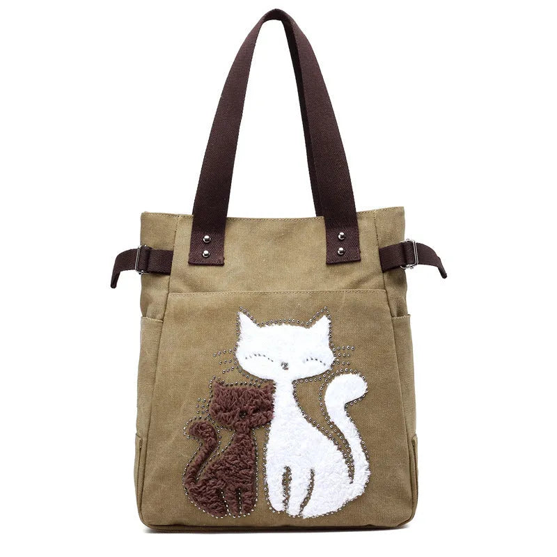 KVKY canvas handbag with plush cat applique in beige colour on a woman's shoulder