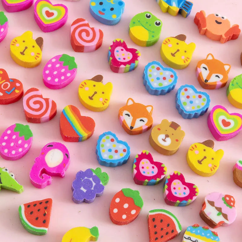 Assortment of colourful TPR cartoon mini erasers showing fruit, animal, and cake designs from a 50-piece pack.