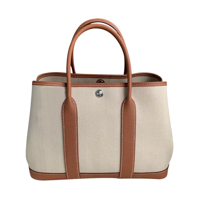 Women's genuine leather and canvas bucket tote bag with crossbody strap in black, brown, grey, or red colours