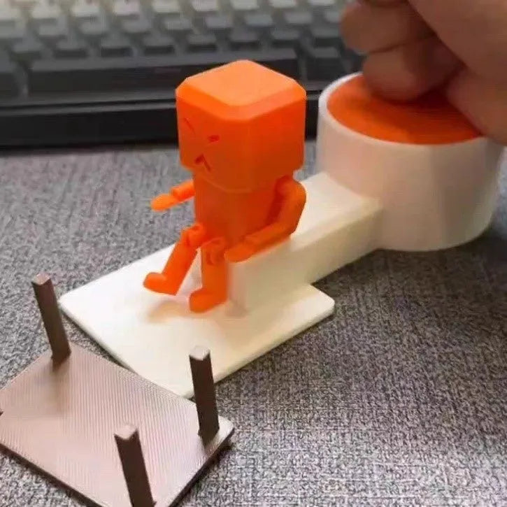 Orange plastic table turning decompression toy artefact on a flat surface.