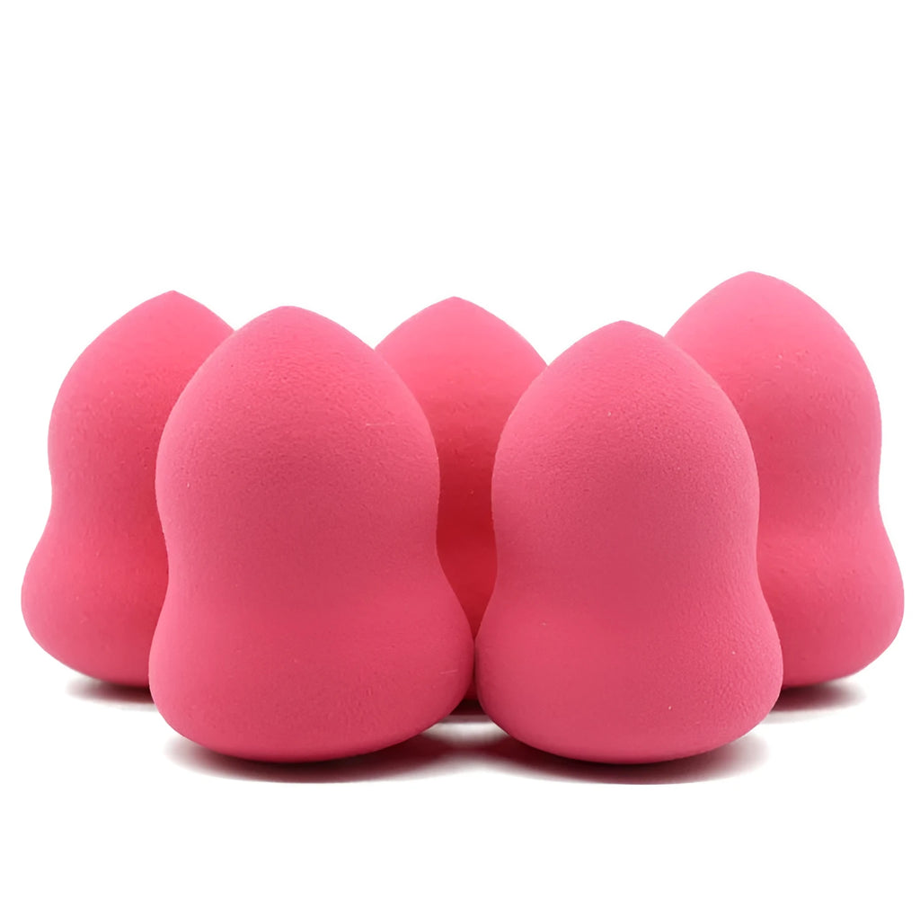 Pink teardrop-shaped makeup blending sponge on a flat surface