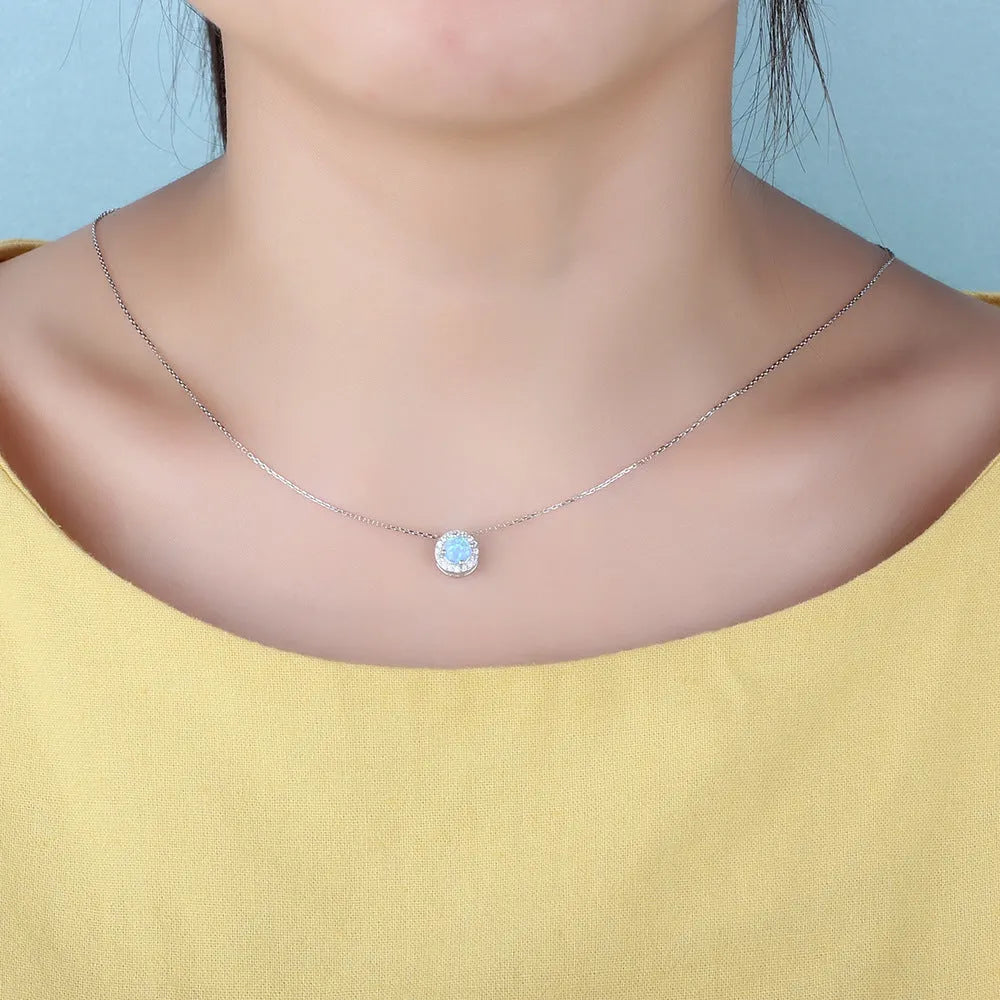 925 silver jewelry set with gem inlay including earrings, collar necklace, and ring on display