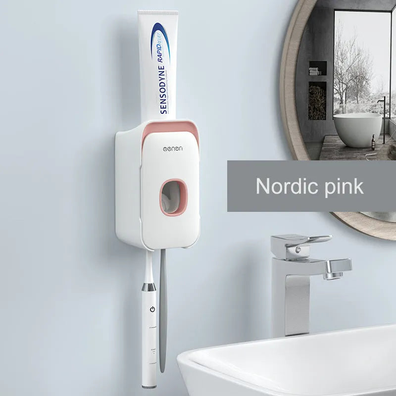 Automatic toothpaste dispenser unit mounted on a wall in a choice of blue, grey, or pink colours.