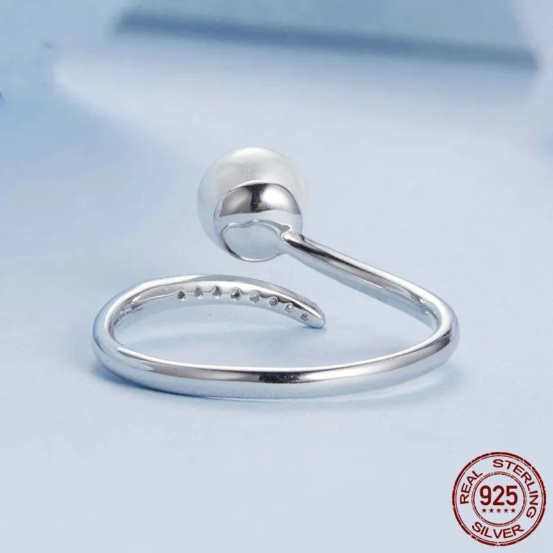 Sterling silver adjustable ring with genuine freshwater shell pearl on minimalist band
