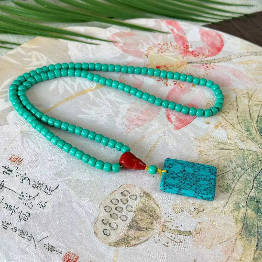 Hand-woven turquoise mesh flower pendant necklace on ball bead chain with adjustable length